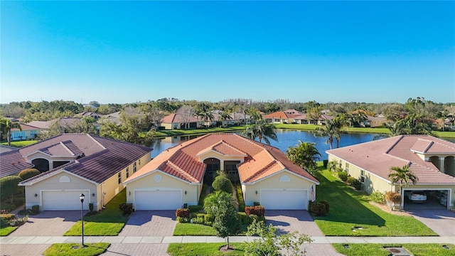 birds eye view of property with a residential view and a water view