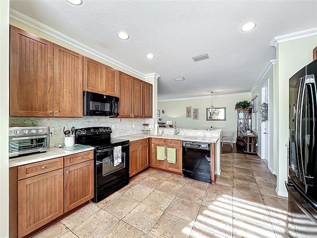 kitchen with decorative backsplash, a peninsula, black appliances, and a sink