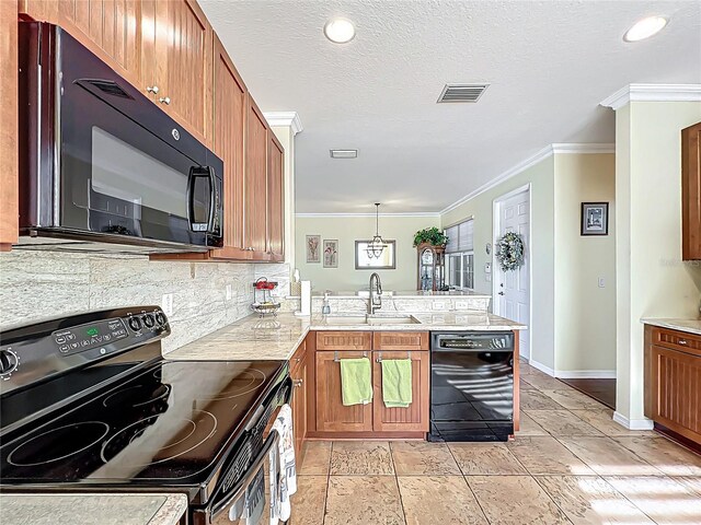 kitchen featuring visible vents, backsplash, crown molding, black appliances, and a sink