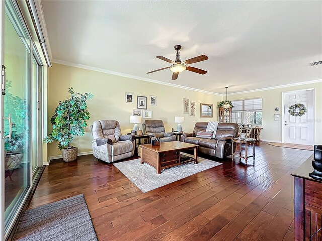 living room featuring baseboards, dark wood-style floors, a ceiling fan, and ornamental molding