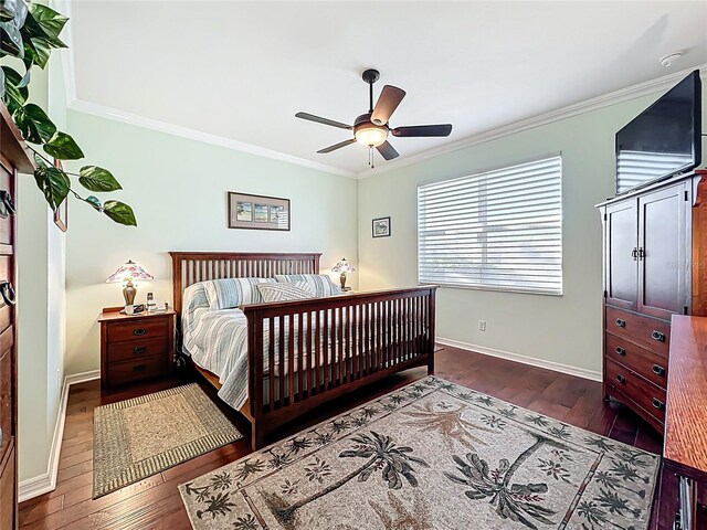 bedroom with hardwood / wood-style floors, baseboards, ornamental molding, and a ceiling fan