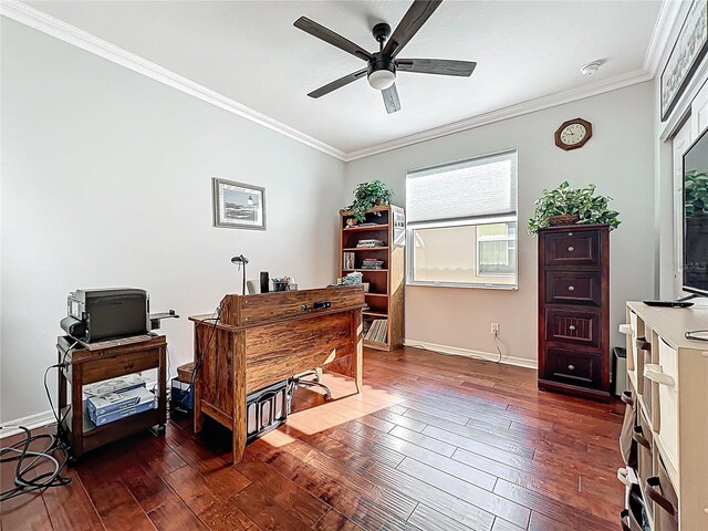 office space featuring dark wood-style floors, a ceiling fan, crown molding, and baseboards