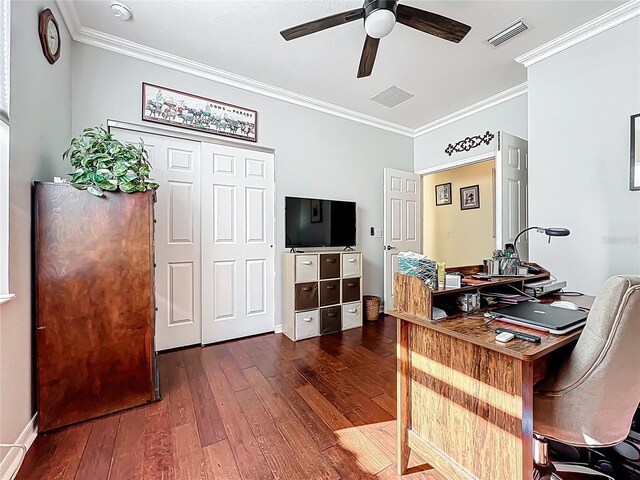 office space with visible vents, dark wood-style floors, a ceiling fan, and ornamental molding