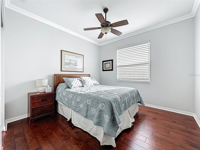 bedroom featuring ceiling fan, baseboards, dark wood finished floors, and crown molding