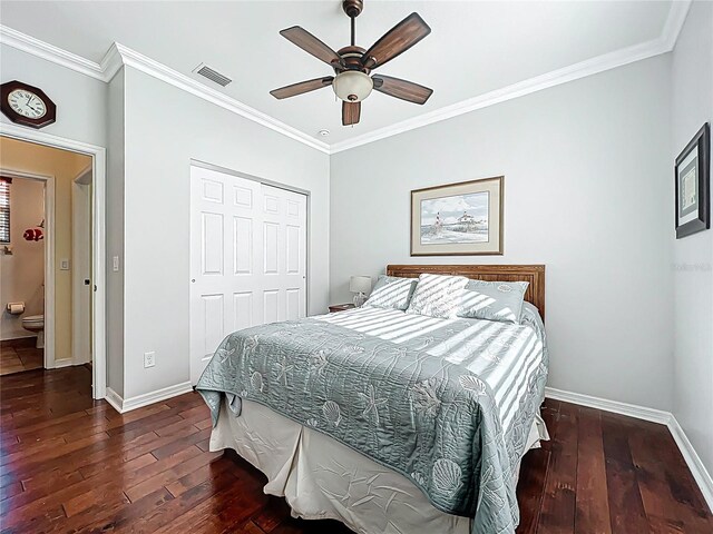 bedroom with hardwood / wood-style floors, crown molding, baseboards, and visible vents