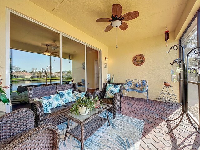 exterior space featuring a wealth of natural light, ceiling fan, and a water view