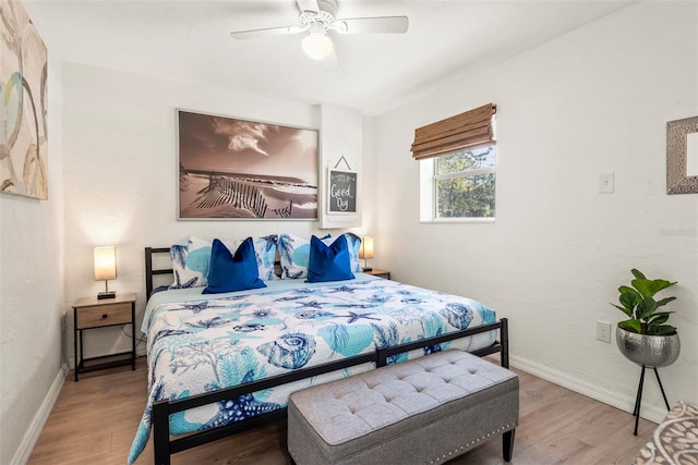 bedroom with wood finished floors, baseboards, and ceiling fan