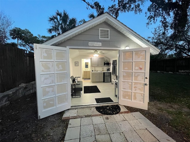 view of outdoor structure featuring an outbuilding and fence