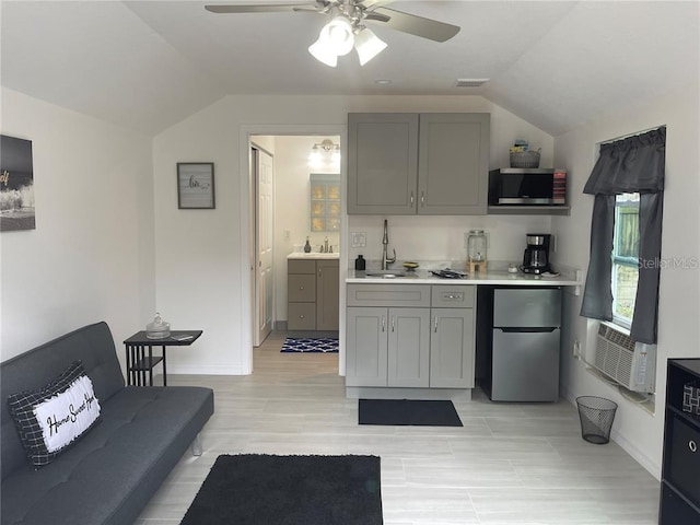 kitchen featuring gray cabinetry, ceiling fan, light countertops, appliances with stainless steel finishes, and a sink