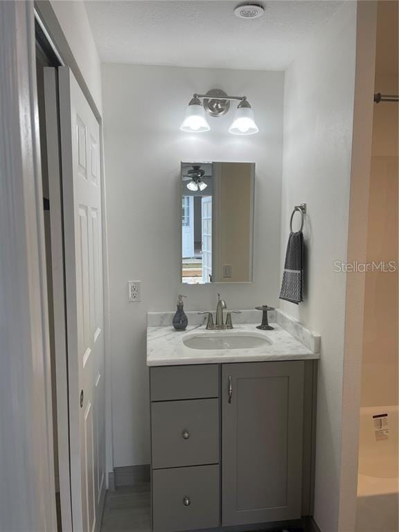 bathroom with ceiling fan and vanity