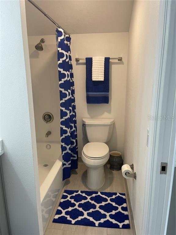 full bathroom with toilet and shower / bath combo