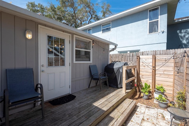 deck featuring a fenced backyard and grilling area