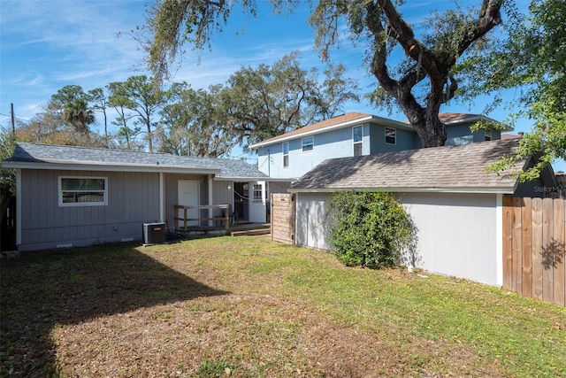 rear view of house featuring fence, central air condition unit, a wooden deck, a yard, and crawl space