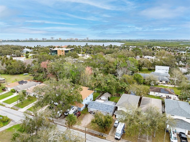 drone / aerial view featuring a city view and a water view