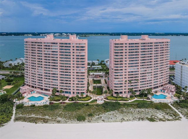 birds eye view of property with a water view and a city view