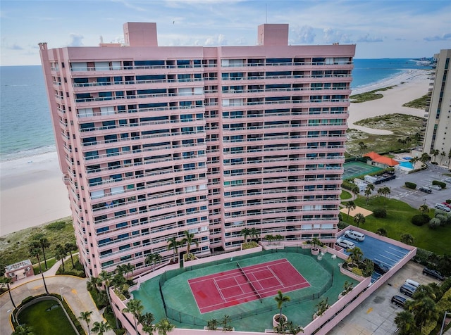 view of property with a water view and a view of the beach