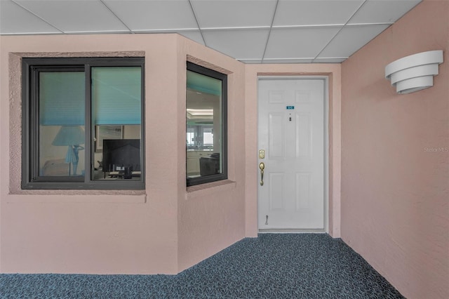 doorway to property featuring stucco siding