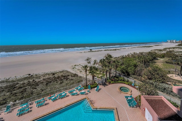 birds eye view of property with a view of the beach and a water view