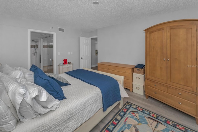 bedroom featuring visible vents and a textured ceiling