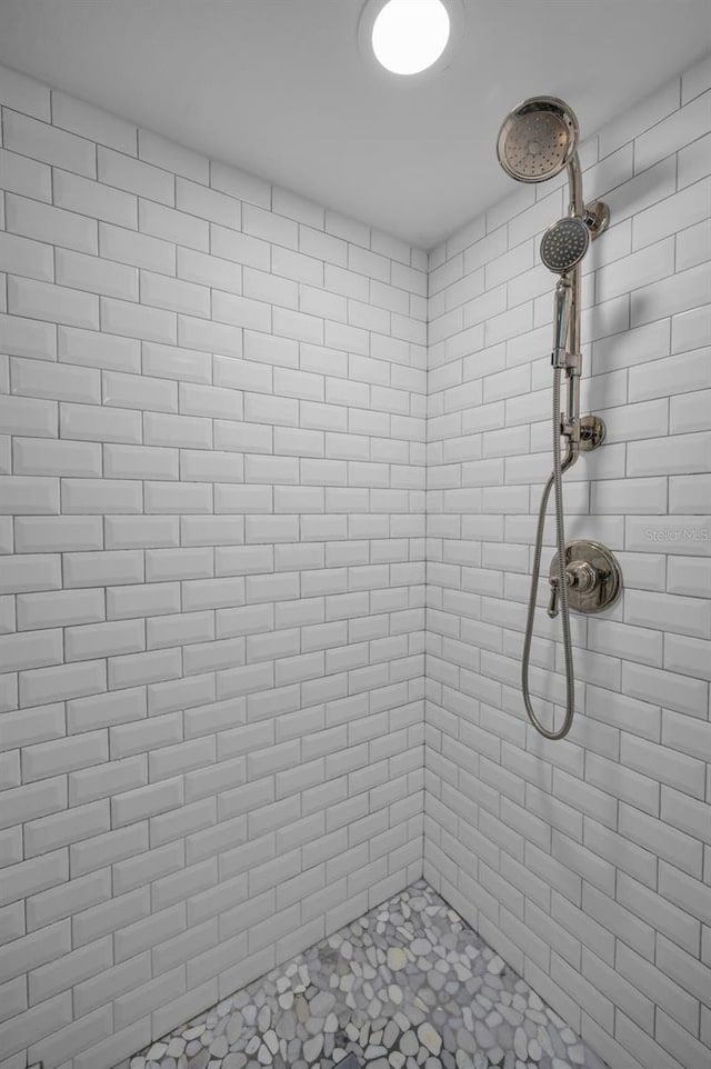 full bath with a tile shower