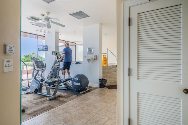 workout area with ceiling fan, light tile patterned floors, and visible vents