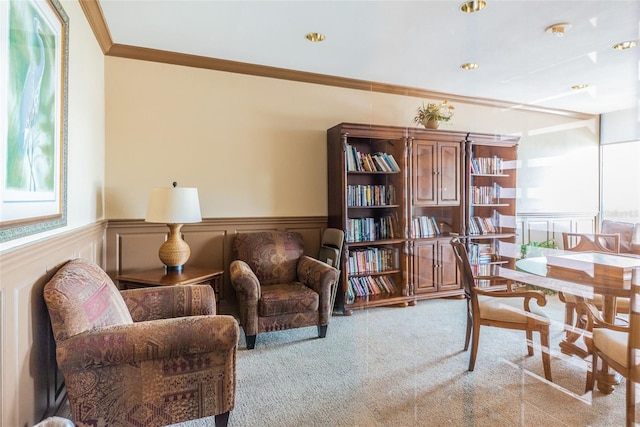 interior space with a healthy amount of sunlight, a wainscoted wall, ornamental molding, and carpet flooring