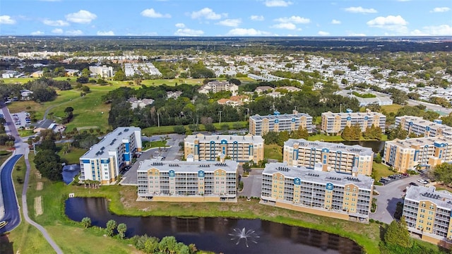 birds eye view of property with a water view and a view of city