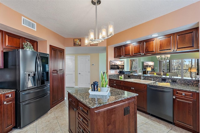 kitchen featuring fridge with ice dispenser, visible vents, a sink, stainless steel dishwasher, and light tile patterned floors