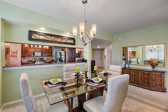 dining area with baseboards, carpet, a chandelier, and a textured ceiling