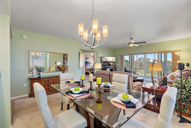 dining room with ceiling fan with notable chandelier, light colored carpet, baseboards, and a textured ceiling