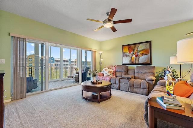 living area with carpet flooring and ceiling fan