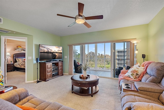 living room with visible vents, light carpet, a textured ceiling, and ceiling fan