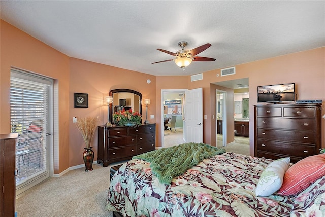 bedroom with access to exterior, visible vents, light colored carpet, and baseboards