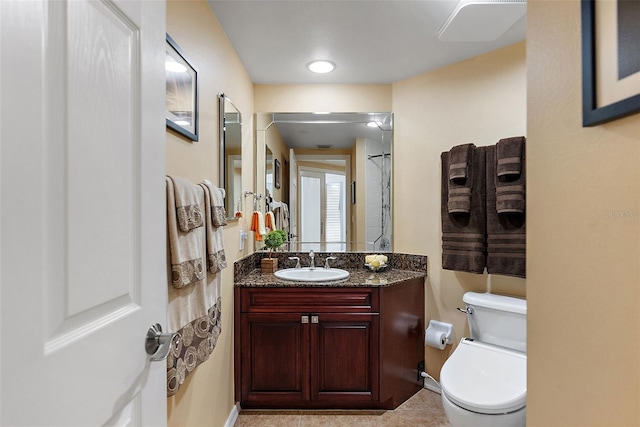 bathroom featuring vanity, toilet, and baseboards