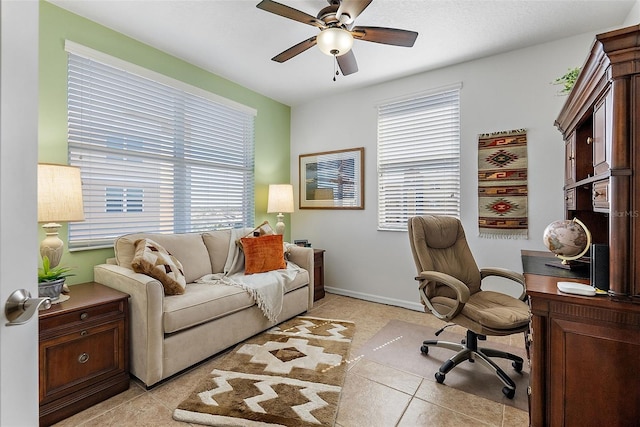 office space featuring light tile patterned floors, baseboards, and ceiling fan