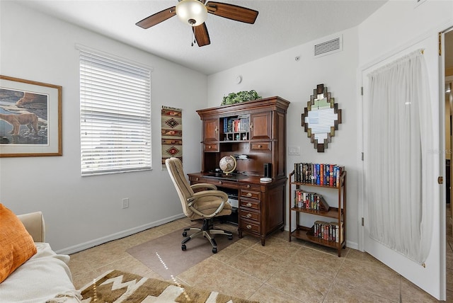 office space featuring a ceiling fan, light tile patterned flooring, baseboards, and visible vents