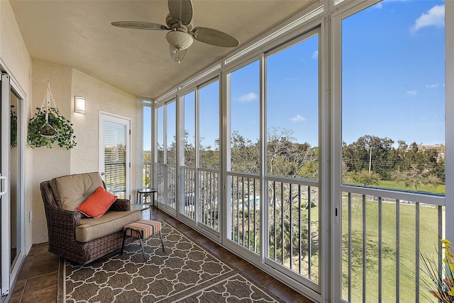 sunroom / solarium featuring ceiling fan