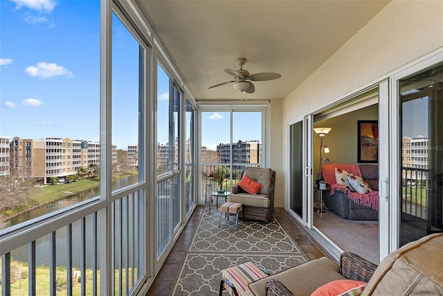 sunroom featuring a city view and a ceiling fan