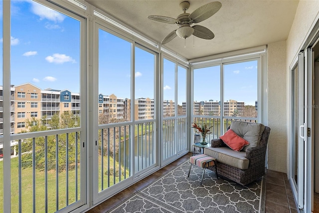 sunroom / solarium with a view of city and ceiling fan