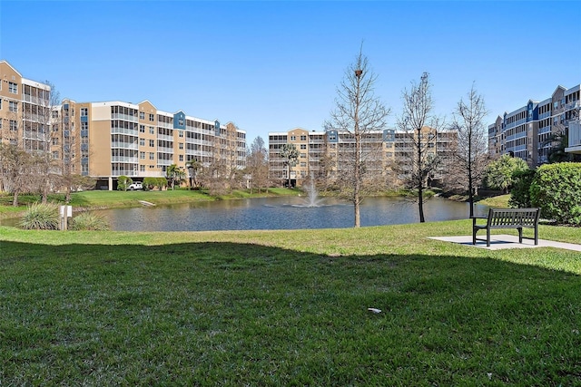 surrounding community with a yard and a water view