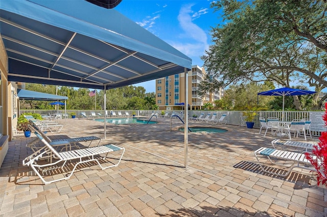 view of patio featuring a community pool and fence