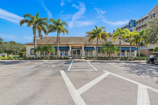 view of property featuring uncovered parking