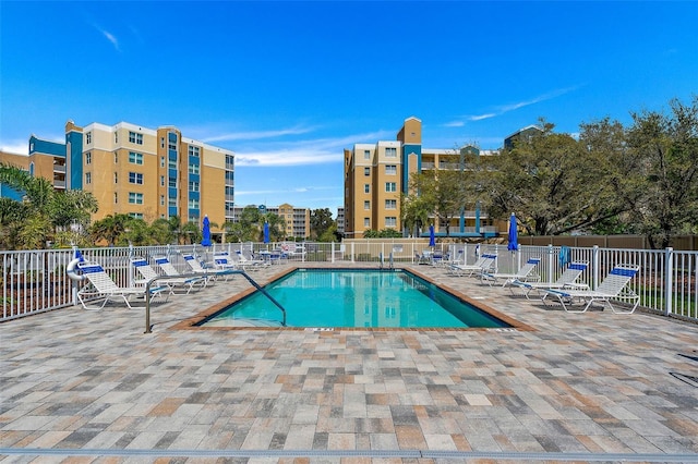 community pool featuring a patio and fence