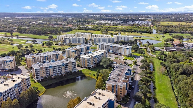 aerial view with a city view, view of golf course, and a water view