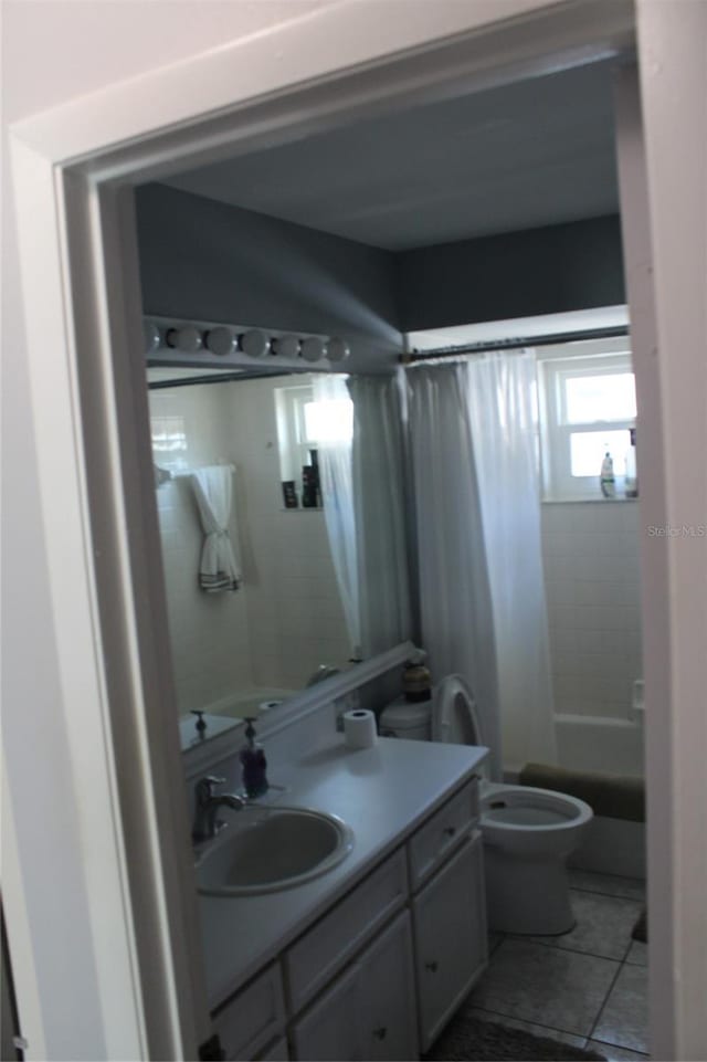 bathroom with shower / tub combo, vanity, toilet, and tile patterned floors