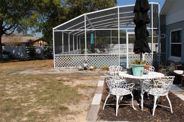 back of property featuring a lanai and a patio