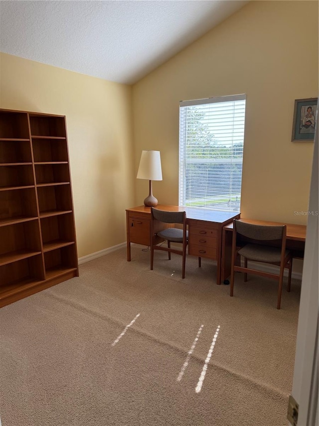 carpeted home office with baseboards, vaulted ceiling, and a textured ceiling