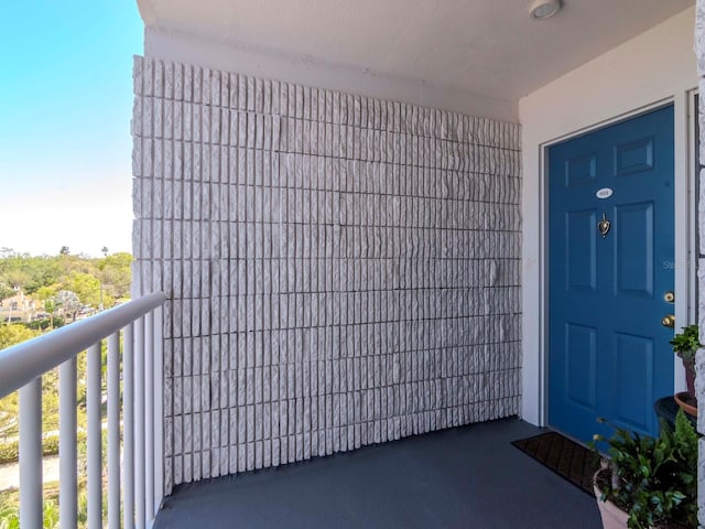 doorway to property featuring a balcony and stucco siding