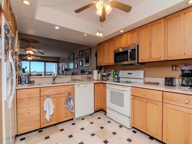 kitchen with light floors, white appliances, light countertops, and a sink