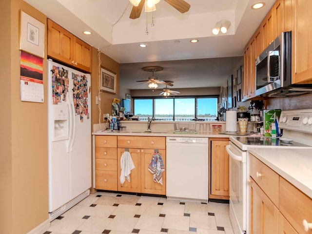 kitchen with white appliances, recessed lighting, light floors, and light countertops